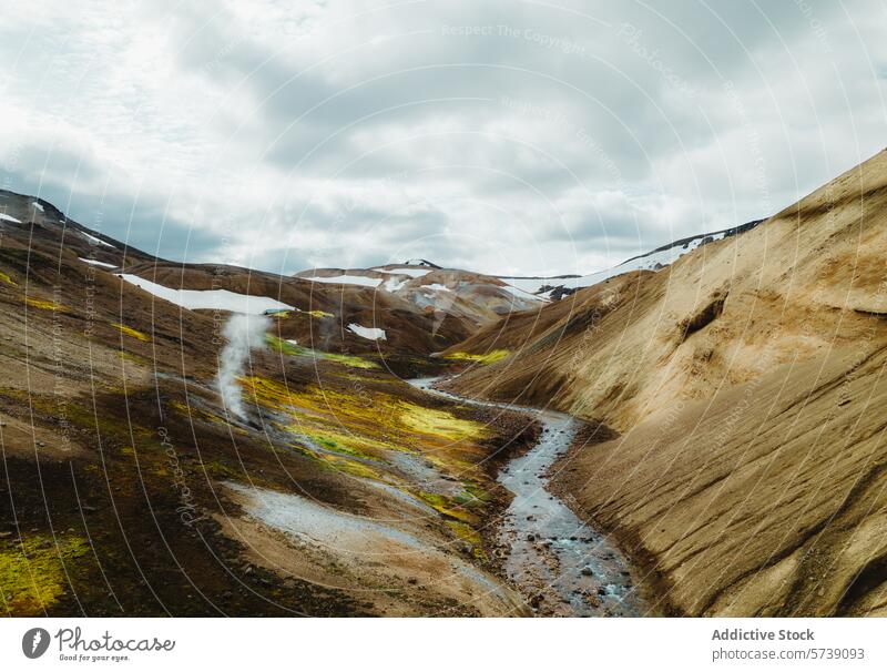 Steam rising from geothermal river in Icelandic hills iceland steam snow landscape nature outdoor sediment colorful travel scenic volcanic terrain geology