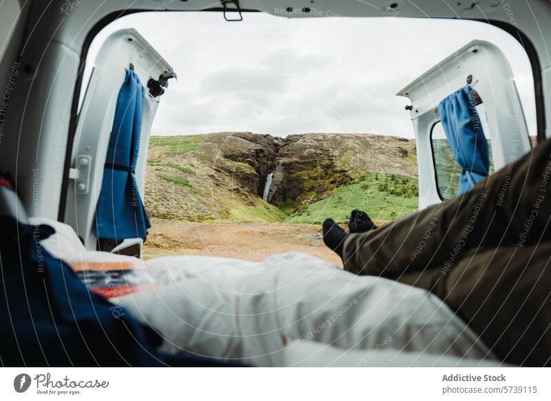 Van life view of a waterfall in Iceland's rugged terrain iceland camper van adventure travel landscape nature open doors van life road trip scenic outdoors