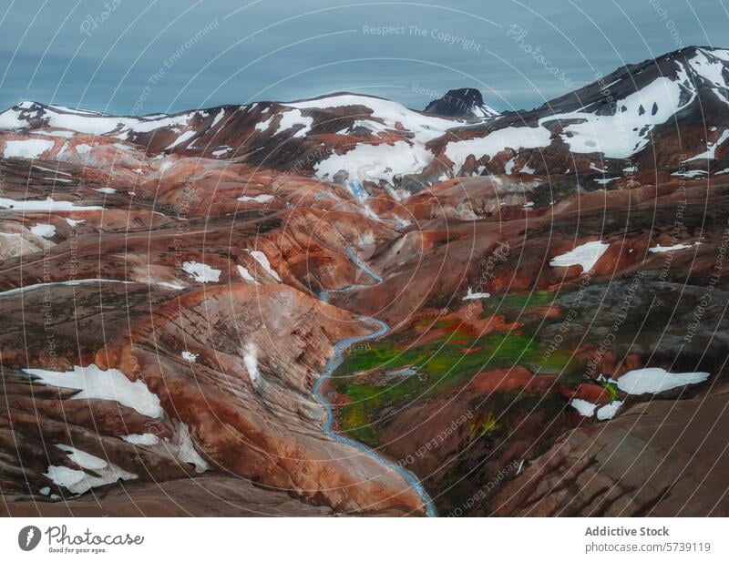 Majestic volcanic landscape with colorful rhyolite mountains in Iceland iceland aerial view vibrant hue snow river meandering blue patch stunning natural beauty