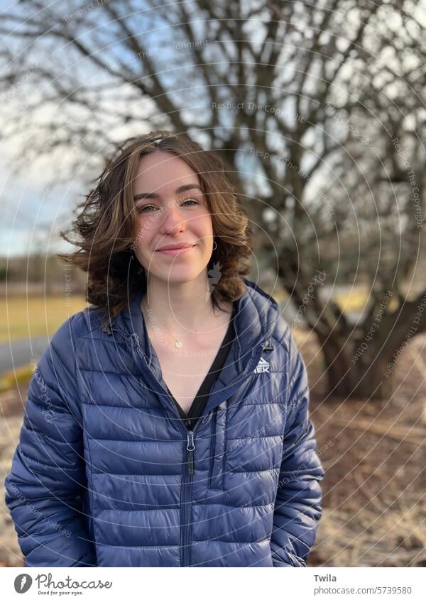 Young woman in front of leafless apple tree Feminine Beautiful Face Colour photo 18 - 30 years Exterior shot Portrait photograph