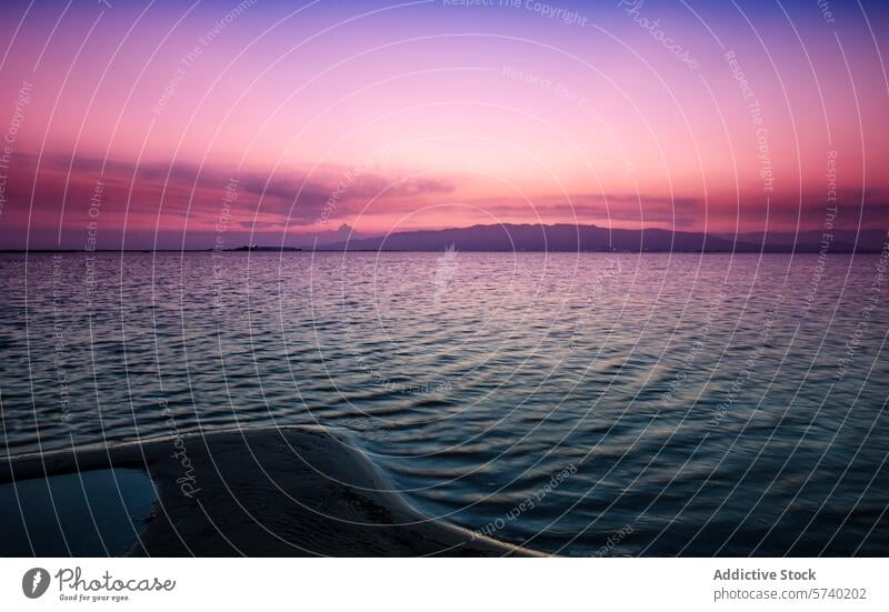 A boat's bow gently cuts through the waters of Delta del Ebro under a spectacular sunset sky painted in shades of pink and purple dusk serenade tranquil serene