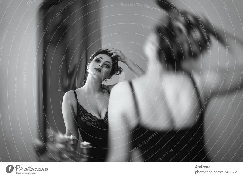 young brunette model girl and actress in front of a mirror, black and white pearls beads play role fashion drama history herself in the room armchair sofa sit