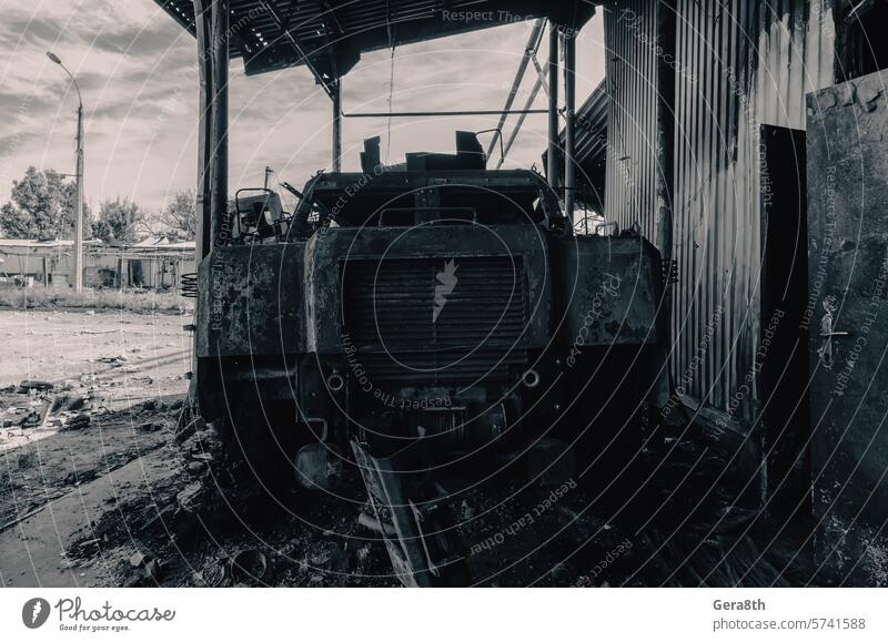 burnt military armored car on the street of the ruined city Donetsk Kherson Lugansk Mariupol Russia Ukraine abandon abandoned attack blown up bombardment broken