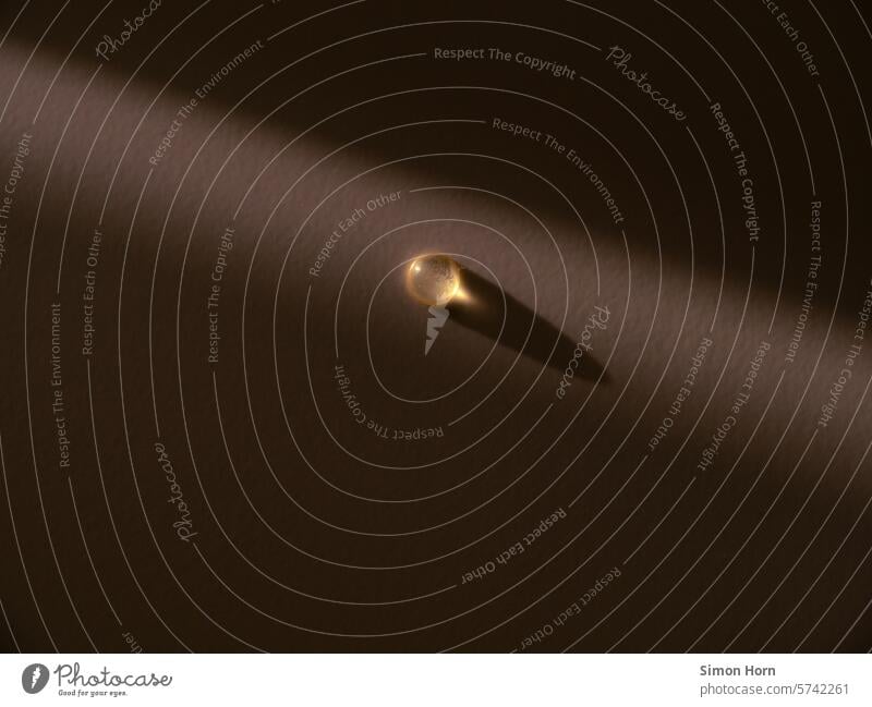 Beam of light hits a drop of water Mood lighting Drop Shaft of light Light (Natural Phenomenon) Drops of water Visual spectacle Illuminate bright spot golden