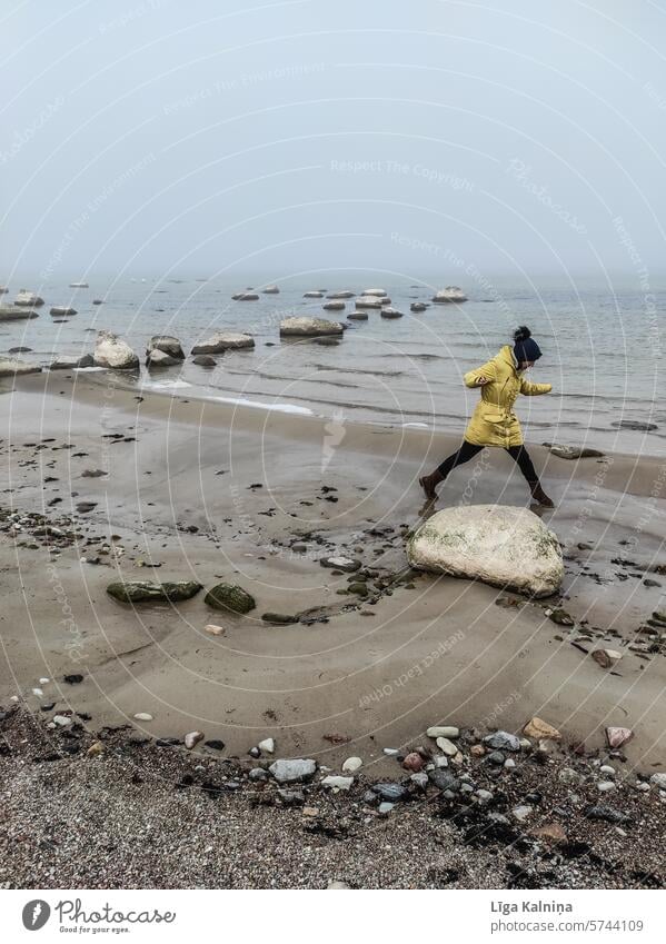 Girl walking on beach in cold weather Beach Sandy beach Summer Vacation & Travel Ocean Nature sandy coast Summer vacation Sunlight Exterior shot Rain Cold