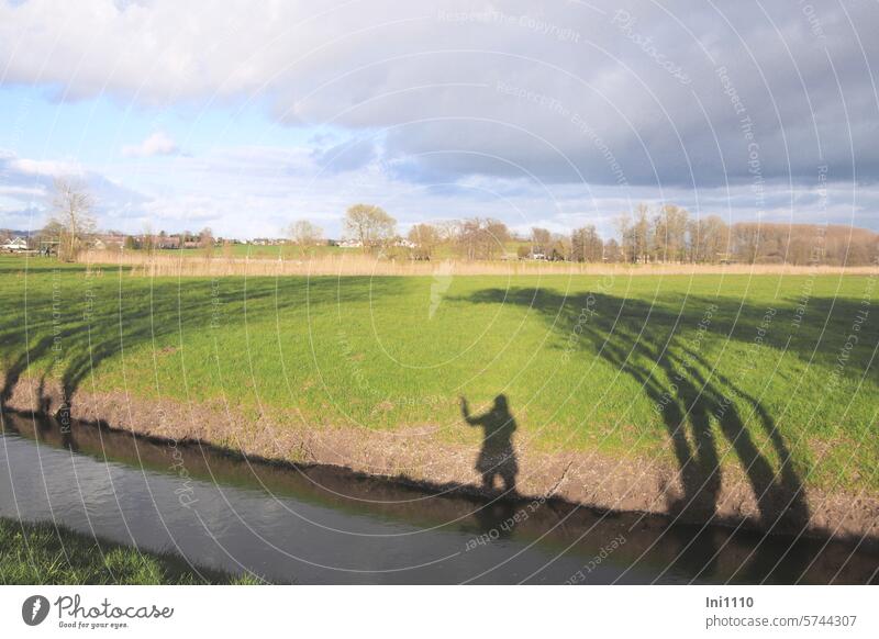 Shadow image with low winter sun Nature Winter sunshine Cold Landscape Late afternoon low sun Field Meadow River course bank Opposite shadow cast Shadow play