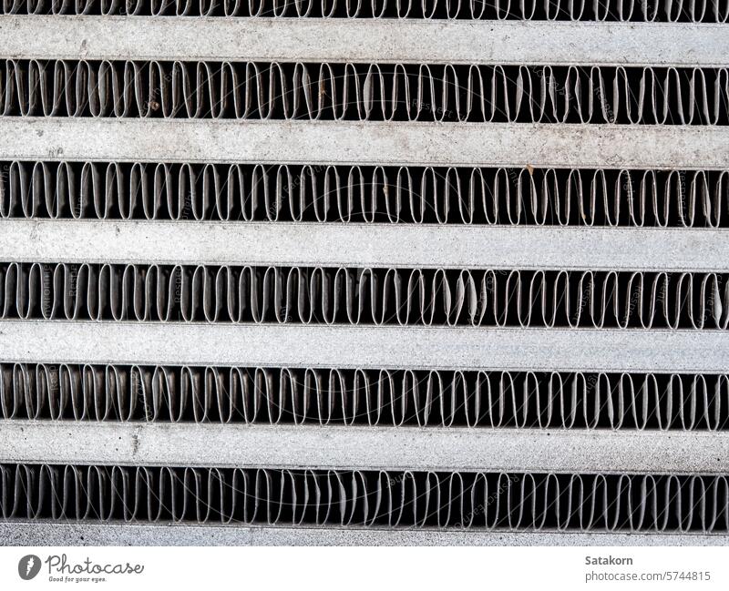 The metal grill of a car radiator is old and has scale marks texture cooling part vehicle grunge detail automotive white engine background equipment