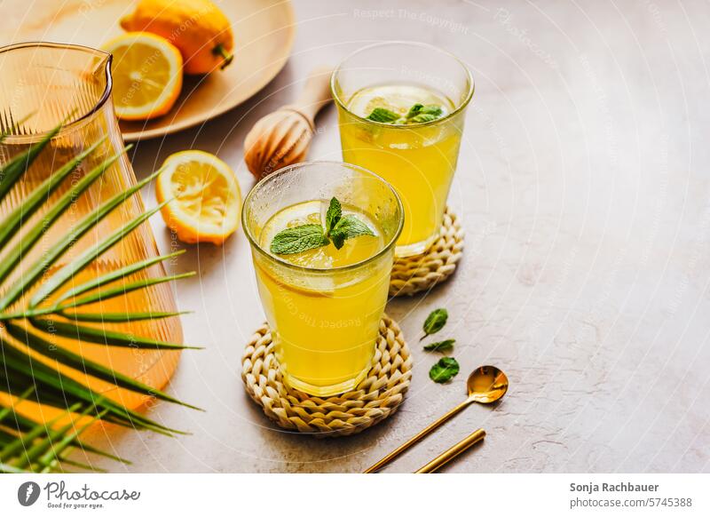 Homemade lemonade on a gray table Cold drink Summer Lemon Self-made Lemonade Glass Yellow Colour photo Beverage Fresh Drinking Fruit Refreshment Citrus fruits