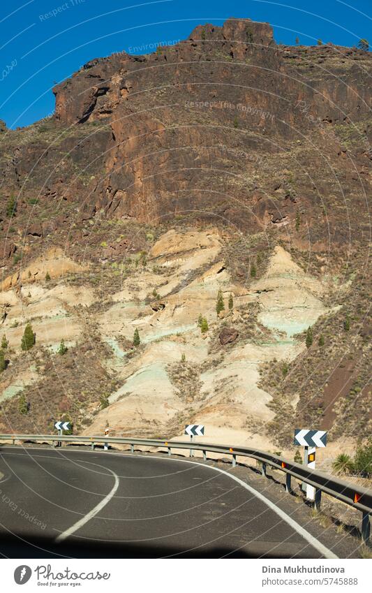 winding road in the mountains with a view over peaks of rocks and mountain in sunny weather in Gran Canaria island gran canaria adventure road trip travel