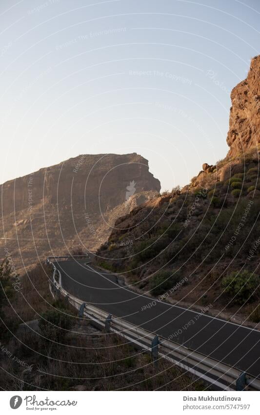 winding road in the mountains with a view over peaks of rocks and mountain in cloudy weather in Gran Canaria island gran canaria adventure road trip travel