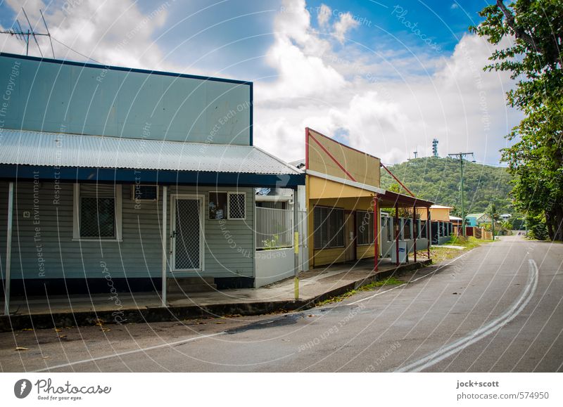 artistic freedom Clouds Warmth Tree Exotic Hill Small Town Outskirts Store premises Facade Canopy Traffic infrastructure Street Marker line Calm Authentic Idyll