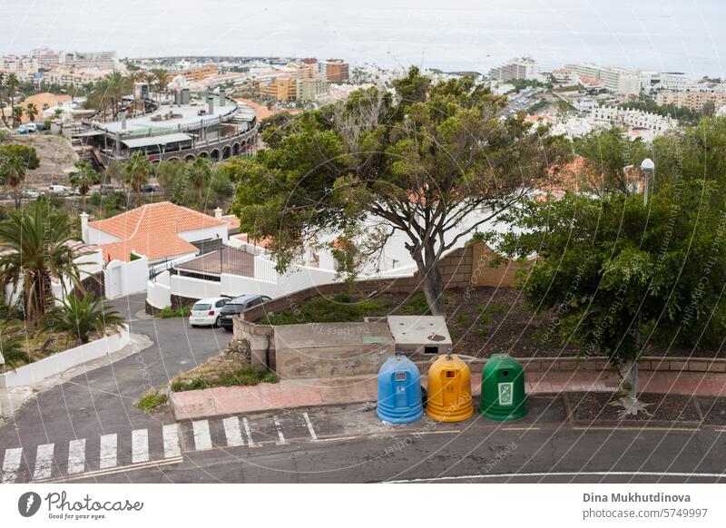 trash bin containers for recycling garbage in Tenerife, Canary Islands, Spain. Separating plastic, glass and paper. Blue, yellow and green container on sidewalk aerial view. Maintenance work. Urban planning. Environment protection.