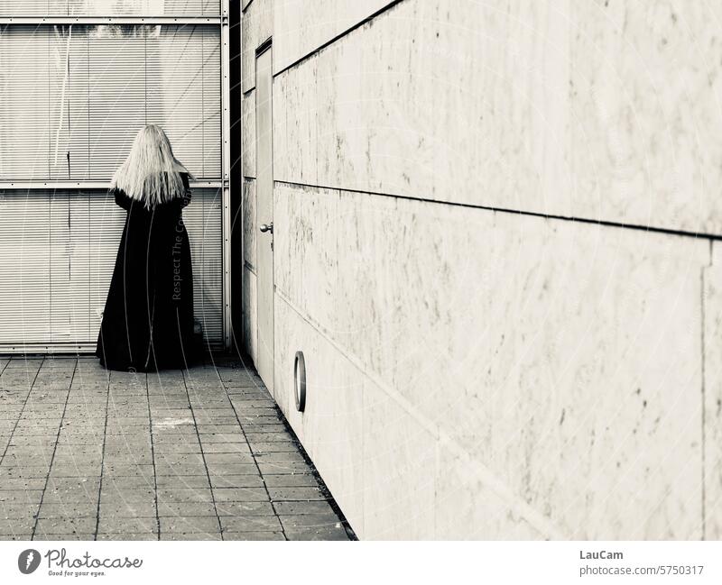 Hide and seek - 3, 2, 1, here I come Woman Corner back view Blonde hair Black coat Coat Mysterious be in the corner Wall (building) Window door Vanishing point