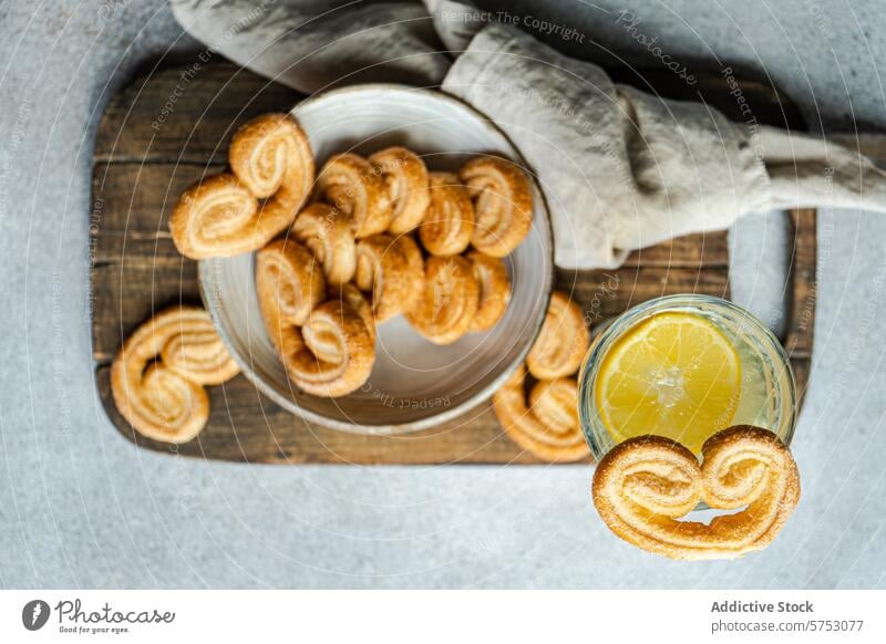 Palmiers or elephant ears, puff pastry cookies in the bowl bake baked baking beverage concrete dessert drink drinking eat eating food glass lemon lemonade