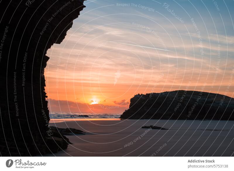 The sun sets over a secluded Spanish beach, its light reflecting off the wet sand and silhouetting dramatic rock formations against a vibrant sky sunset Spain