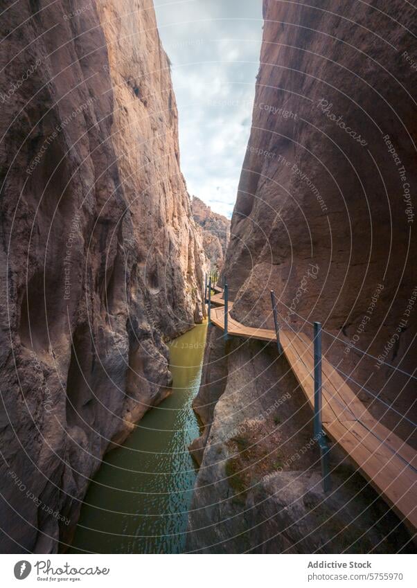 Hiking Trail with Wooden Walkways Between Cliffs hiking trail wooden walkway cliff serene water tranquil experience nature adventure outdoors landscape