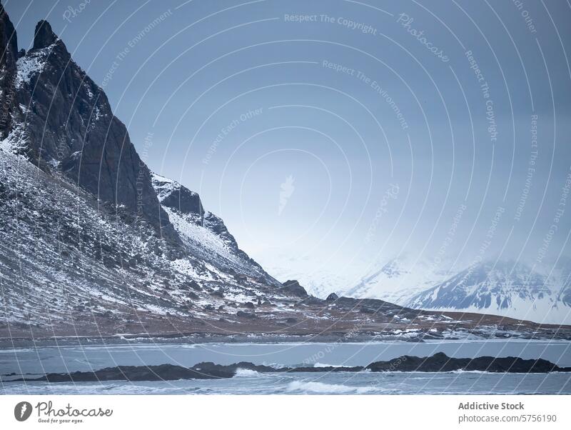 Snowy mountainous landscape with overcast skies in Iceland iceland snow sky majestic serene dramatic nature outdoor winter peak cold travel scenery remote