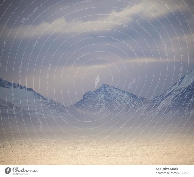 Snow peaks under hazy Icelandic skies iceland mountain snow mist sky landscape nature cold tranquil serene winter frost subtle outdoor travel destination icy