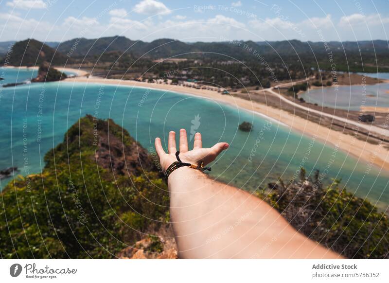 Hand Reaching Out to Indonesian Seascape hand seascape nature coast beach ocean connection travel tourism landscape view outstretched reach summer tropical bay