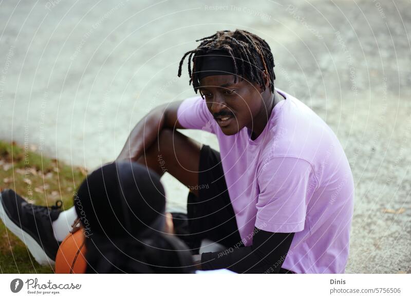 Friends hanging out after game of streetball, discussing news and problems slope out friend buddy homie serious issue talk black man millennial Park sportswear