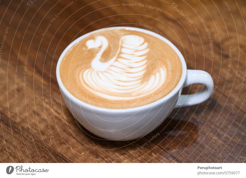 Artistic latte swan design on wooden table art coffee espresso cappuccino barista cafe culture milk foam creamy texture cup white close beverage gourmet shop