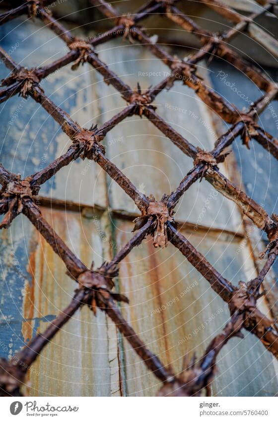 The ravages of time - Rusted grille in front of an old window corroded Old Derelict launched Window Metal Transience Decline Ravages of time Detail