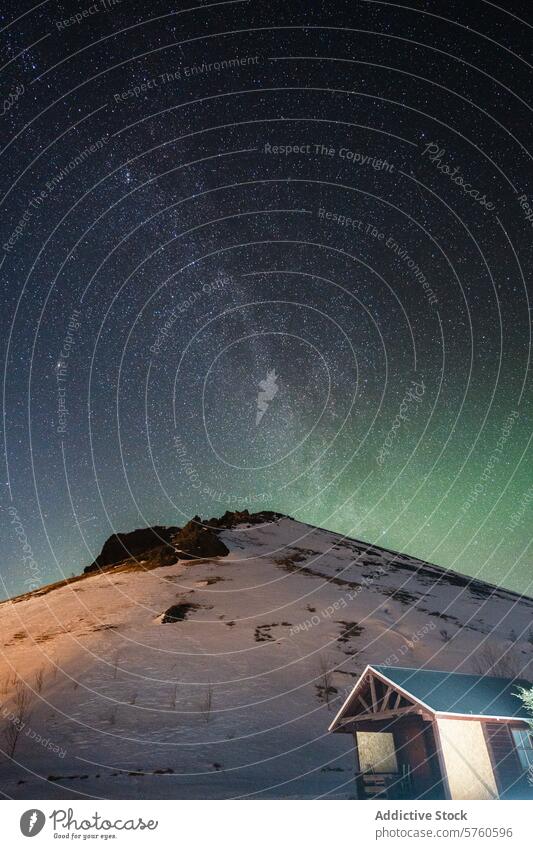 A breathtaking view of the star-studded sky and subtle Northern Lights over a snowy hill, beside a quaint Icelandic cabin starry night winter stars