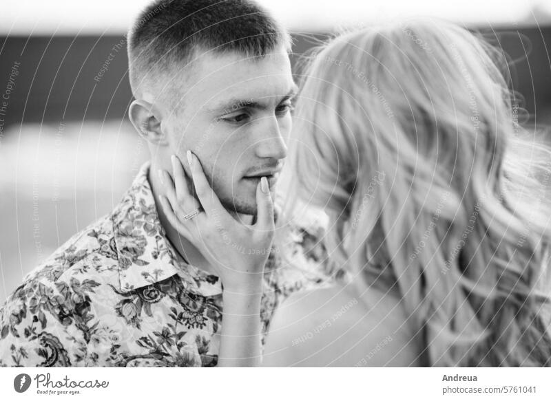 blonde girl in a light blue dress and a guy in a light shirt in a granite quarry boyfriend young teenager for a walk together gravel heap gray sand mountains