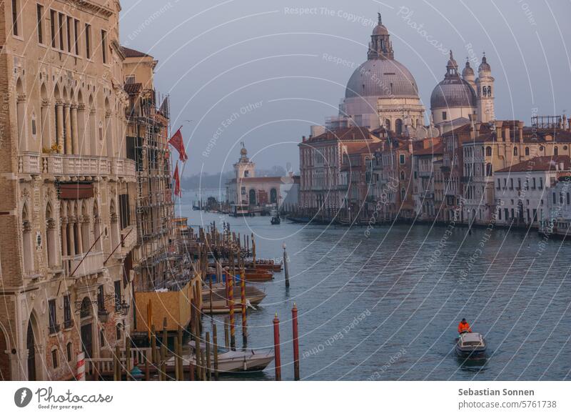 View of Grand Canal and Basilica Santa Maria della Salute seen from the Rialto Bridge on a hazy winter evening, Venice, Veneto, Italy italy europe travel venice