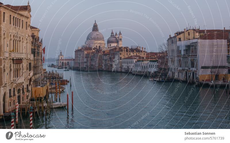 View of Grand Canal and Basilica Santa Maria della Salute seen from the Rialto Bridge on a hazy winter evening, Venice, Veneto, Italy italy europe travel venice