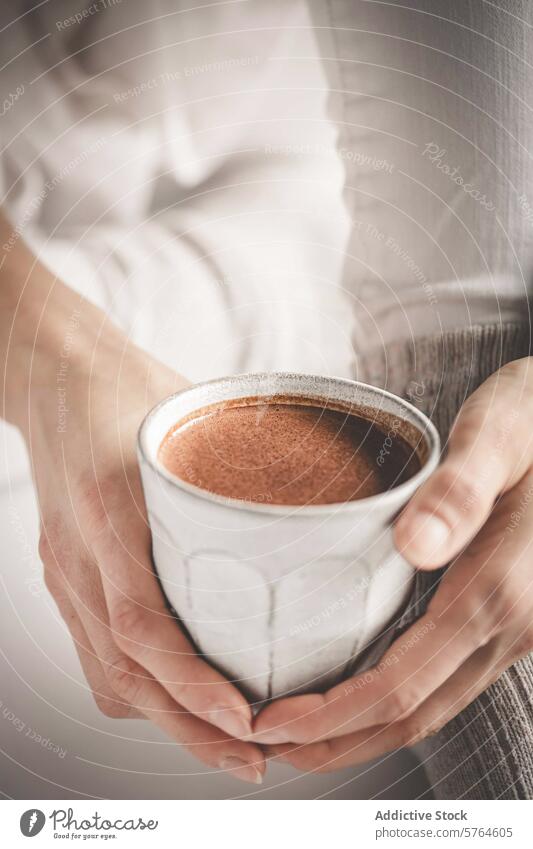 Cozy hands cradling a mug of hot chocolate person comfort cozy warm drink beverage frothy holding cup warmth soothing homemade drinkware ceramic cozy atmosphere