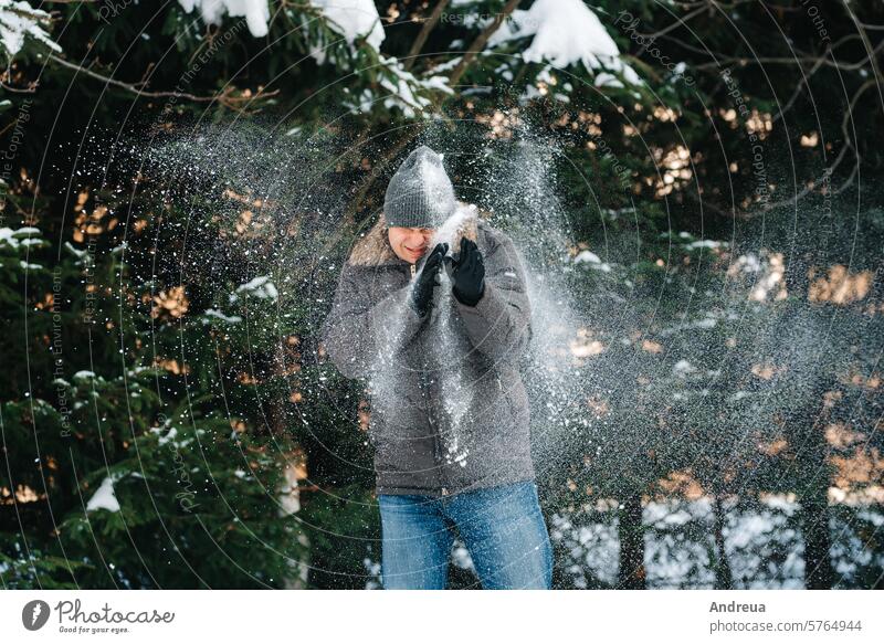 boy and girl outdoors on a winter walk playing snowballs walking sled game day sun outside in the yard white clean wet joy love people happiness jackets warm