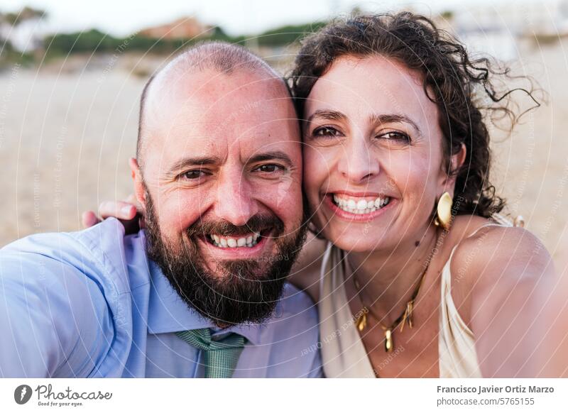 Couple Taking a Selfie at Beach Sunset selfie couple beach sunset love romance vacation sea sand happiness smartphone photography memory travel holiday sky