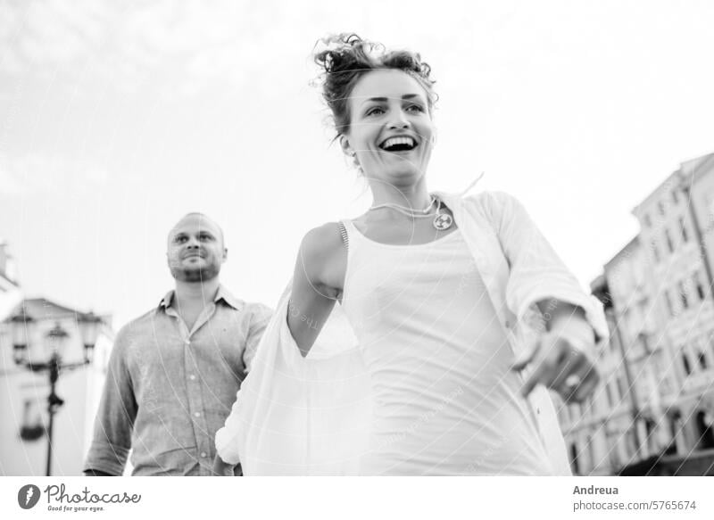 guy and a girl happily walk in the morning on the empty streets young hairstyle brown alone stone walls old fashionable europe joy counting emotions glasses