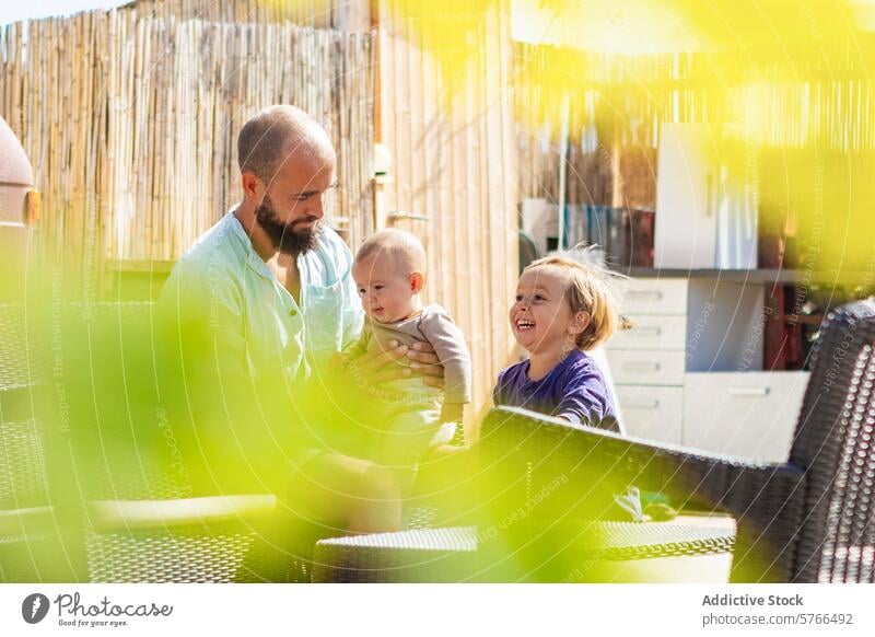 Family life in a van with homemade garden and deck family sun outdoor alternative living happiness lifestyle joy bond man woman children baby boy