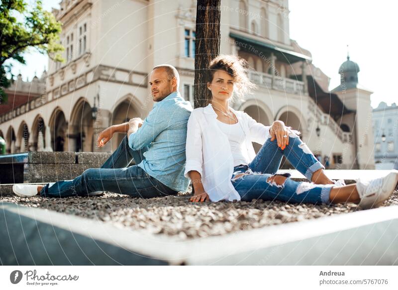 guy and a girl happily walk in the morning on the empty streets young hairstyle brown alone stone walls old fashionable europe joy counting emotions glasses