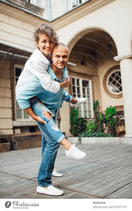 guy and a girl happily walk in the morning on the empty streets young hairstyle brown alone stone walls old fashionable europe joy counting emotions glasses