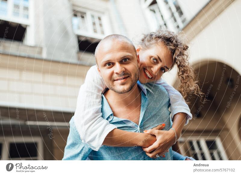 guy and a girl happily walk in the morning on the empty streets young hairstyle brown alone stone walls old fashionable europe joy counting emotions glasses