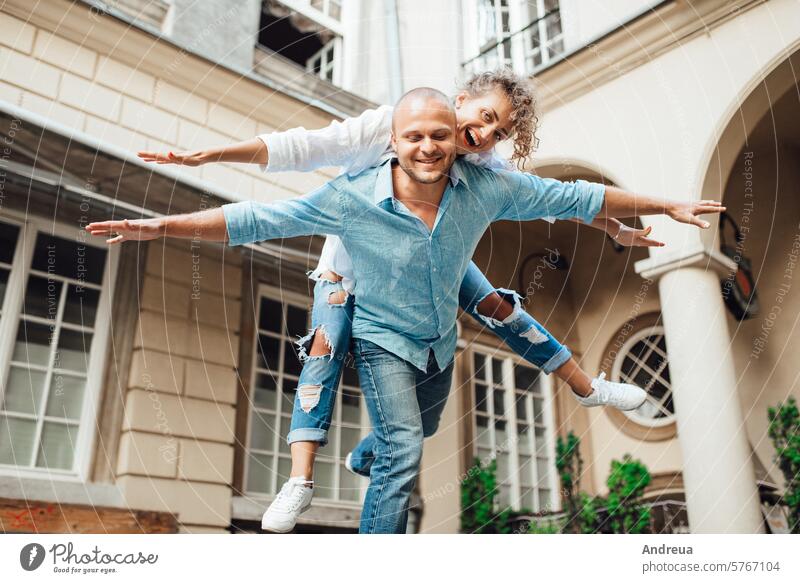 guy and a girl happily walk in the morning on the empty streets young hairstyle brown alone stone walls old fashionable europe joy counting emotions glasses