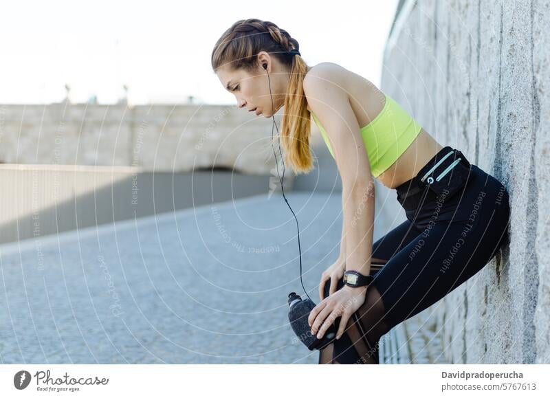 fit happy woman resting after do sport , running and workout fitness stretching exercise young training healthy listening music outdoor beautiful lifestyle park