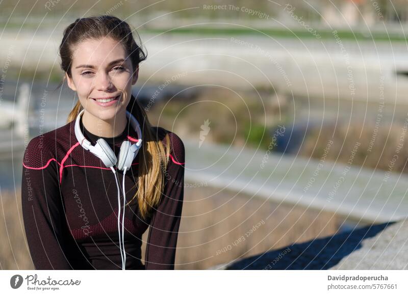 fit happy woman resting after do sport , running and workout fitness stretching exercise young training healthy listening music outdoor beautiful lifestyle park