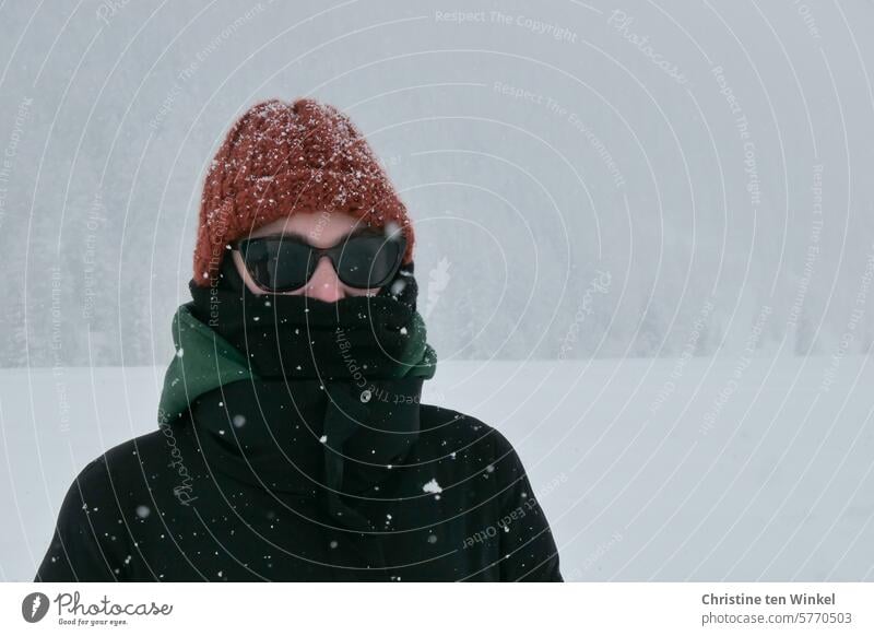 It's snowing! Woman Snow Winter Winter mood Snowfall winter Cap Scarf Winter coat Sunglasses snowy blow snow Cold Winter's day snowflakes snow flurries chill