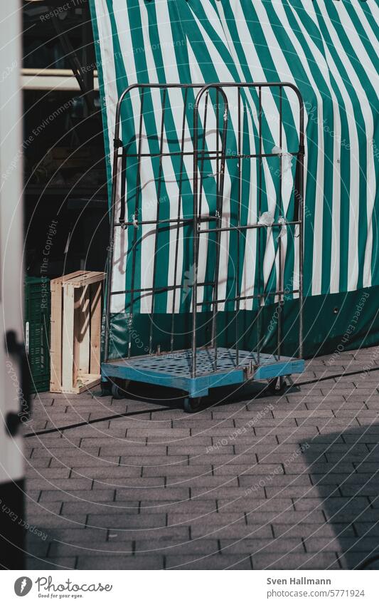 Market cart stands in front of market tent Markets Shopping Farmer's market Market stall Stripe Sell Exterior shot Paving stone Screening stroll Red Hypermarket