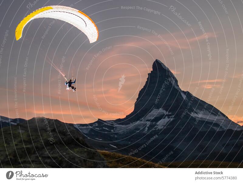 Paragliding at sunset near the iconic Matterhorn peak paraglider matterhorn mountain soaring scenic backdrop majestic height flight adventure sport outdoor