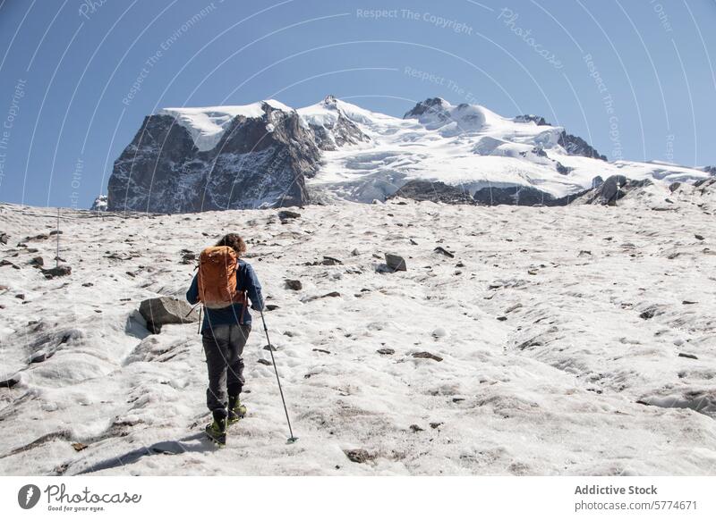 Lone Hiker Venturing Across a Snowy Glacier Landscape adventure glacier hiker hiking snowy terrain solitary adventurer challenging vast peaks snow-covered