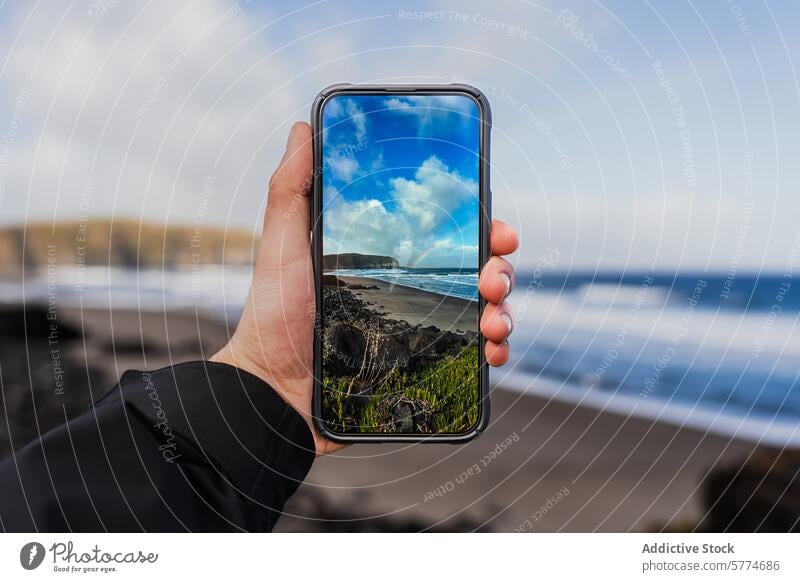 Smartphone capturing scenic view of São Miguel beach smartphone hand scenery perspective são miguel portugal gorreana tea plantation alignment coast ocean sea