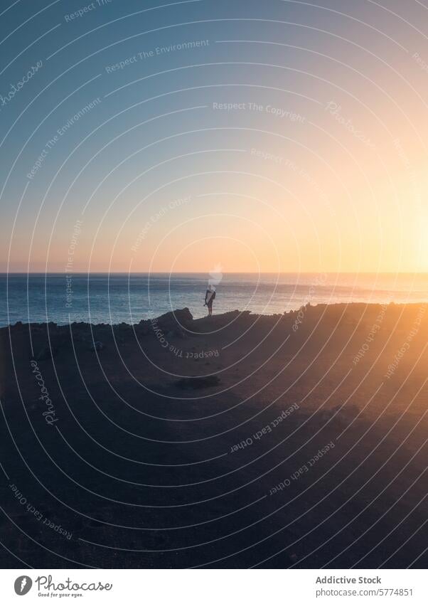 Serene sunset with lone figure on La Palma coastline la palma tranquil scenic atlantic ocean person silhouette nature landscape travel spain horizon calm