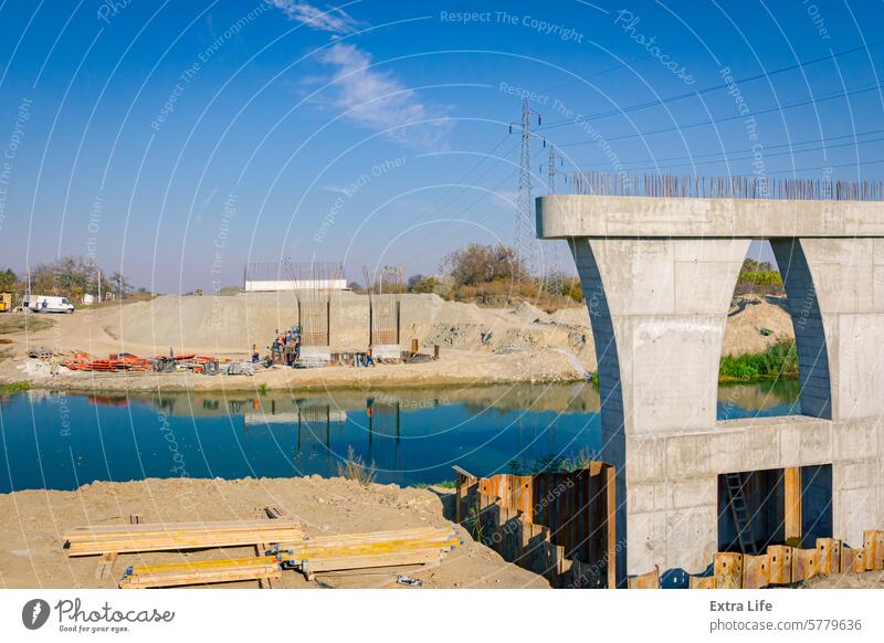 Huge pole in foundation with metal piles, construction of concrete-reinforced bridge pillars at building site Across Alfresco Architectural Architecture