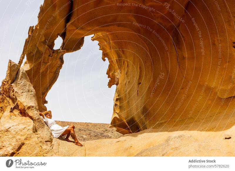 Serene moment of a woman in natural rock formation nature relaxation tranquility serenity leisure arch majestic connection outdoor reclining calm peaceful