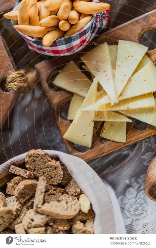 Artisan Cheese and Breadsticks on Wooden Board cheese breadstick biscotti wooden serving tray rustic gourmet slice crisp spread artisan food snack appetizer